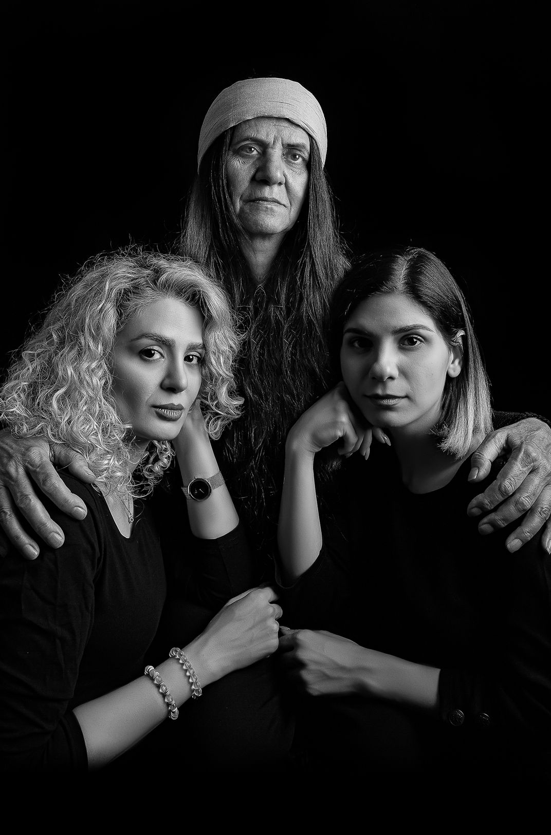 a group portrait of a mother and her two daughters