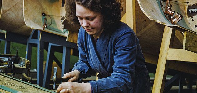 a worker prepares wood strips for a Mosquito hull