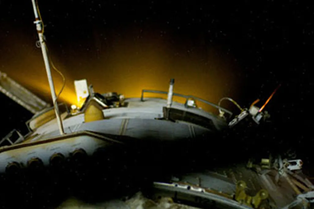 glowing thrusters of a Progress spacecraft