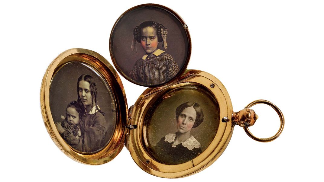 a vitnage locket holding three photographs