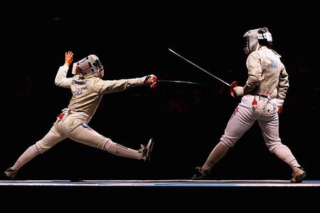 Sada Jacobson Baby (right) of the United States battles with Leonore Perrus of France in the bronze medal match in the Women's Team Sabre event at the 2008 Olympic Games in Beijing.