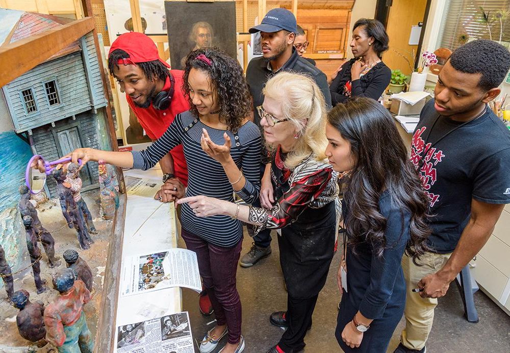Matthew Fields (left) assessing a diorama at the University of Delaware in 2017