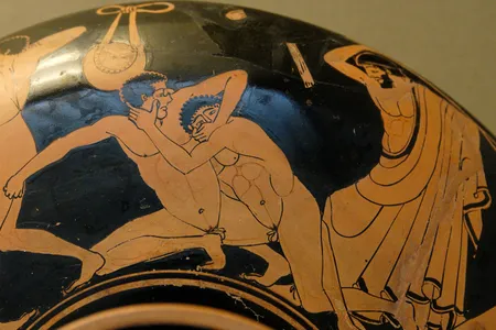 Pankration scene: the pankriatiast on the right tries to gouge his opponent's eye; the umpire is about to strike him for this foul.