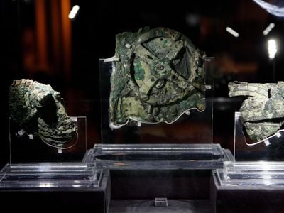 Artifacts from the Antikythera Shipwreck, the famous mechanism in the center, as exhibited in Athens, Greece