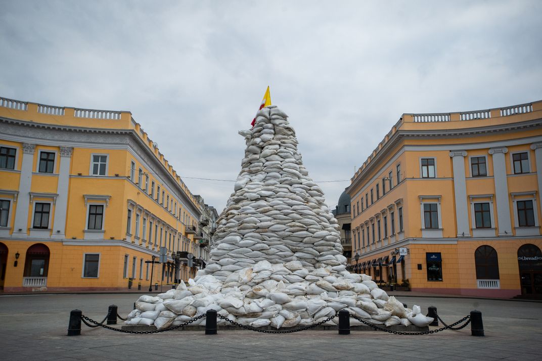 Sandbags piled around a city landmark Odesa Ukrain