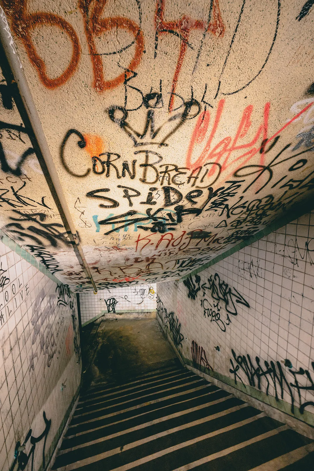 graffiti art shown in an abandoned stairway