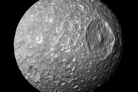 The giant Herschel Crater gives Saturn’s moon Mimas an ominous look.