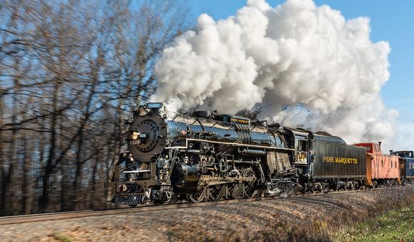 A steam locomotive with smoke billowing