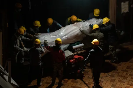 Workers removed the sculpture from the University of Hong Kong&#39;s campus under the cover of night.