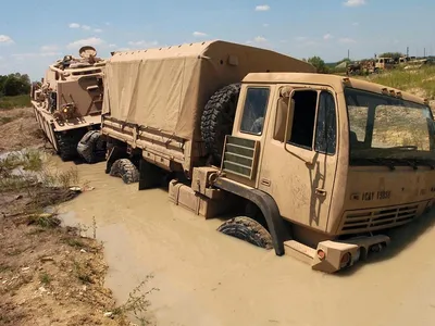 Soldiers use an M88A2 Hercules Recovery Vehicle to pull a truck from a deep puddle of mud during training. Soil moisture data from a NASA satellite could help prevent trucks getting stuck in the first place.