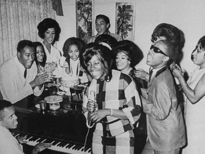 Berry Gordy plays the piano with Motown stars including Stevie Wonder, at right, and Smokey Robinson, at rear behind the piano.