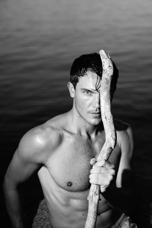 Portrait of male model by lake in black and white thumbnail