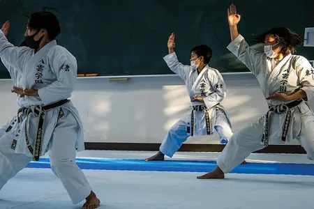 Yakumo Academy High School karate team members practice a kata. Competitors are judged on such things as strength/power, deportment and interpretation.