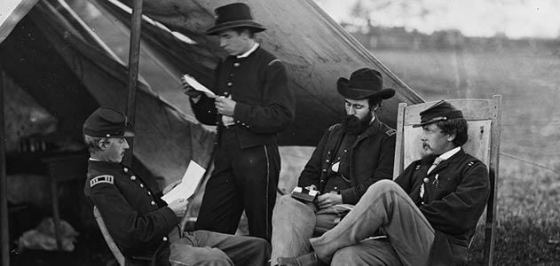 Civil War soldiers reading letters from home