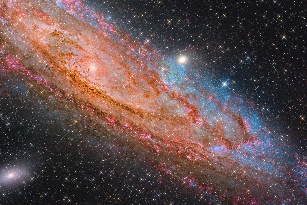 swirling red scattered with blue and pink in outer space