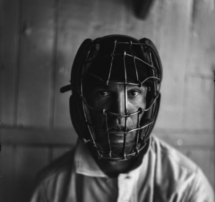 A player wearing an old-fashioned catcher's mask
