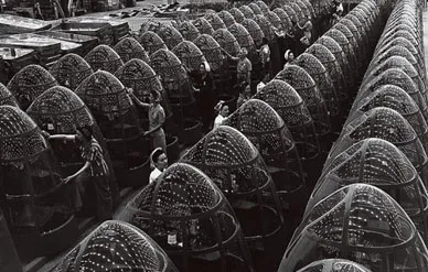 Overhead lights at a factory in Santa Monica, California, are reflected in row upon row of Plexiglas noses destined for Douglas A-20 attack bombers.