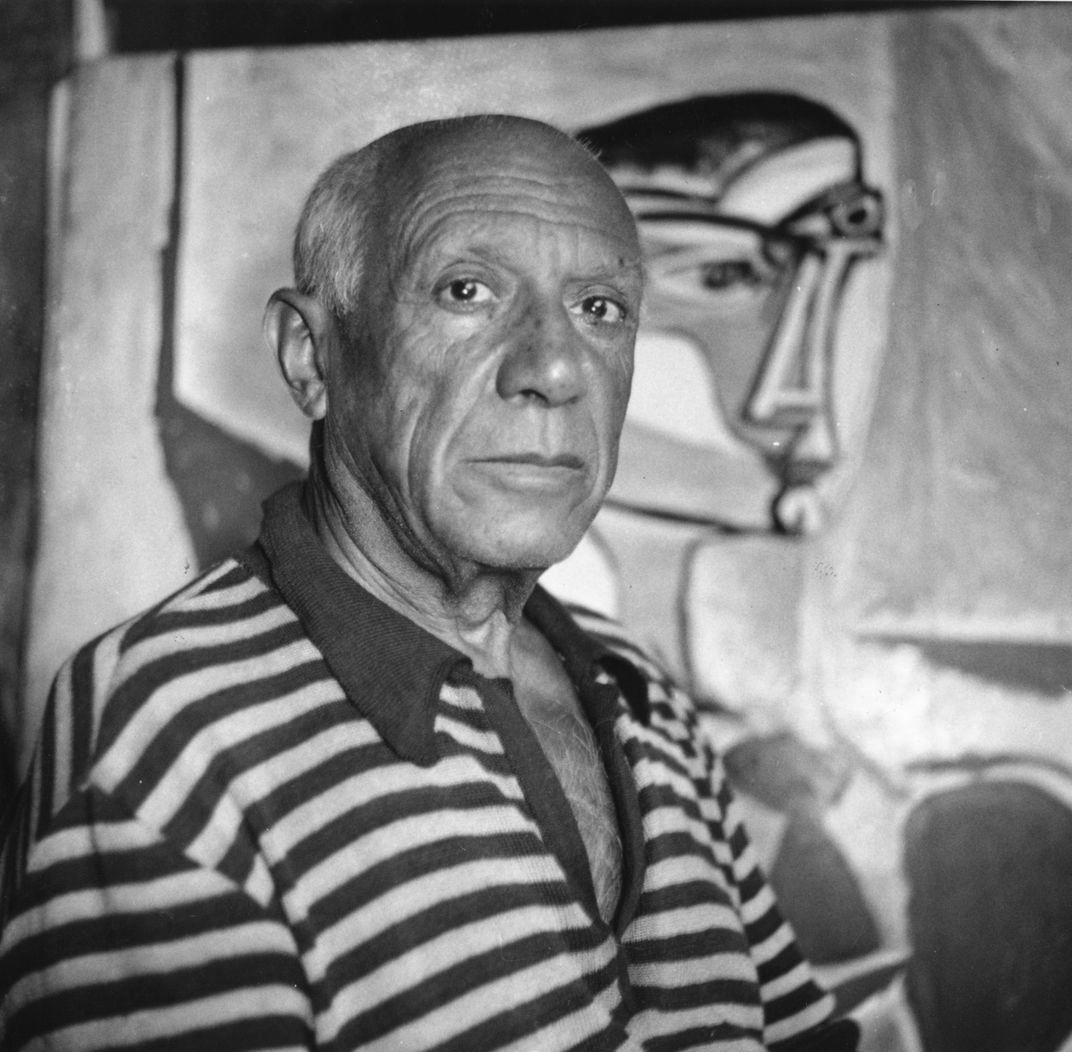 Black and white photo of Picasso with a striped shirt, 1955