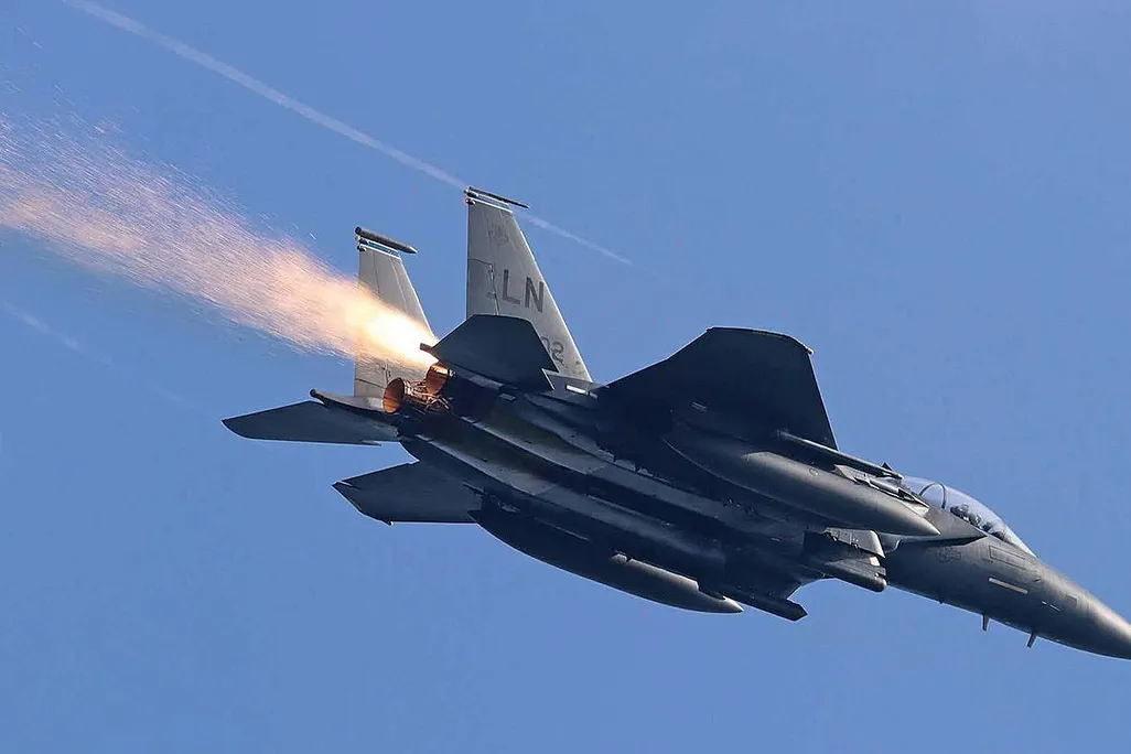 sparks trailing behind F-15E Strike Eagle