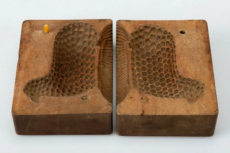 Two wooden textured molds displayed against a white background.