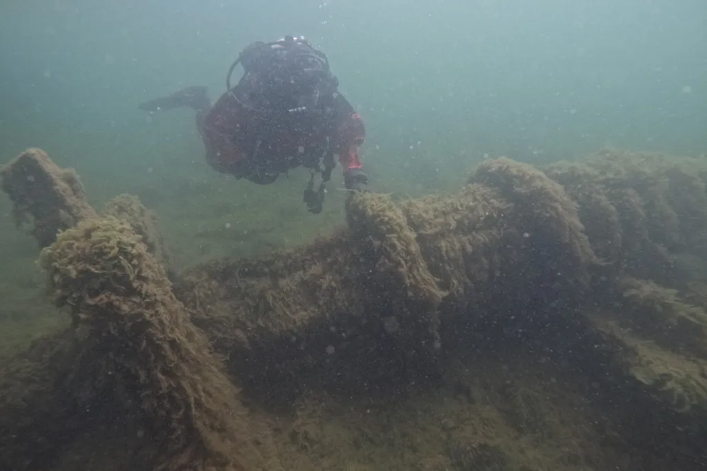 Diver near shipwreck under water