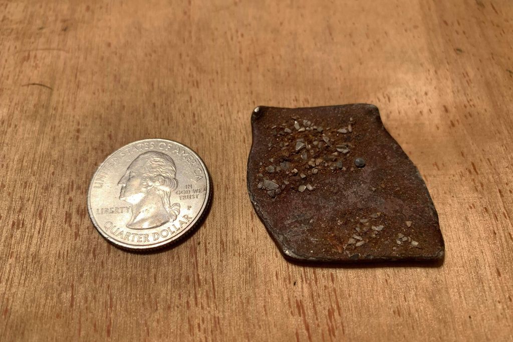 Shipwreck coin next to quarter