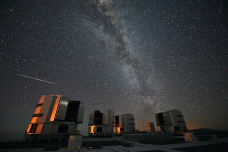 A meteor from the Perseids is seen falling over the Very Large Telescope array in Chile.