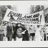Women marching down the street holding a banner with the message “Equal jobs and educational opportunities!”