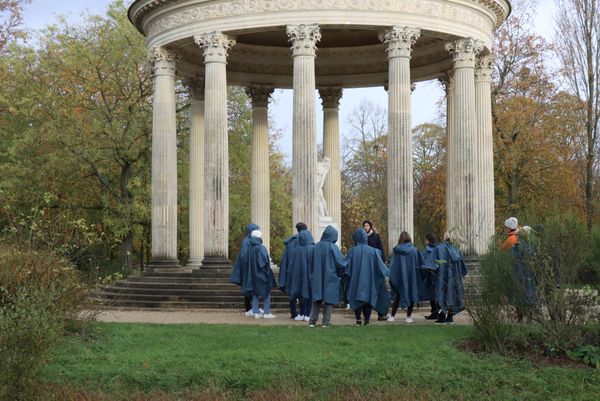 Tourists group wearing raincoat at Versailles. thumbnail