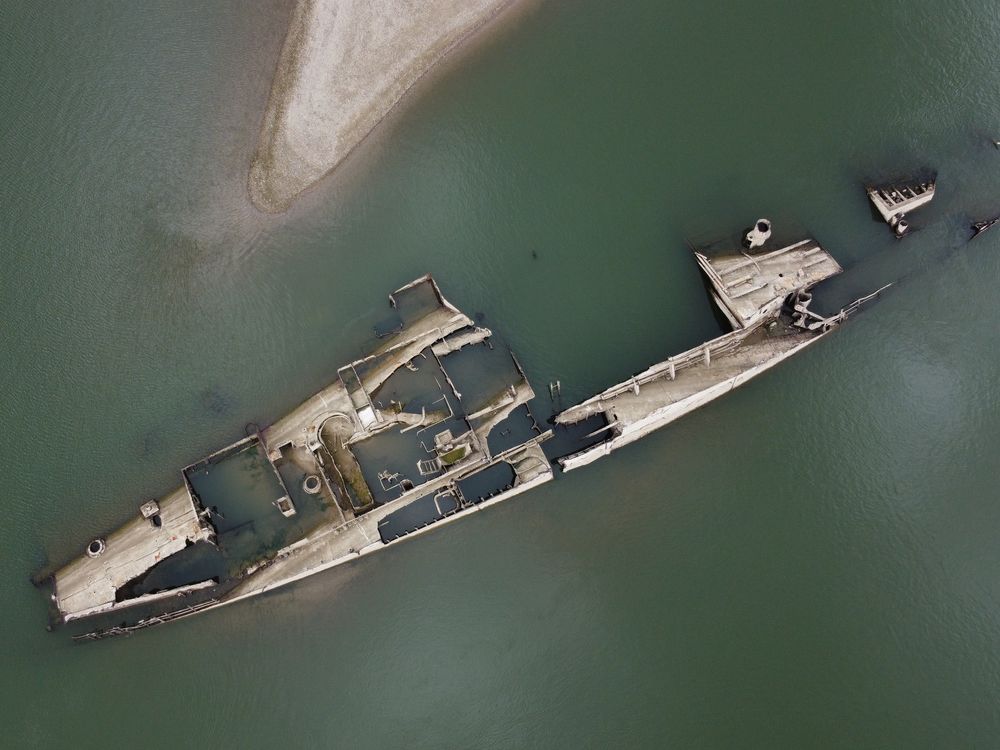Overhead view of shipwreck partially submerged under water