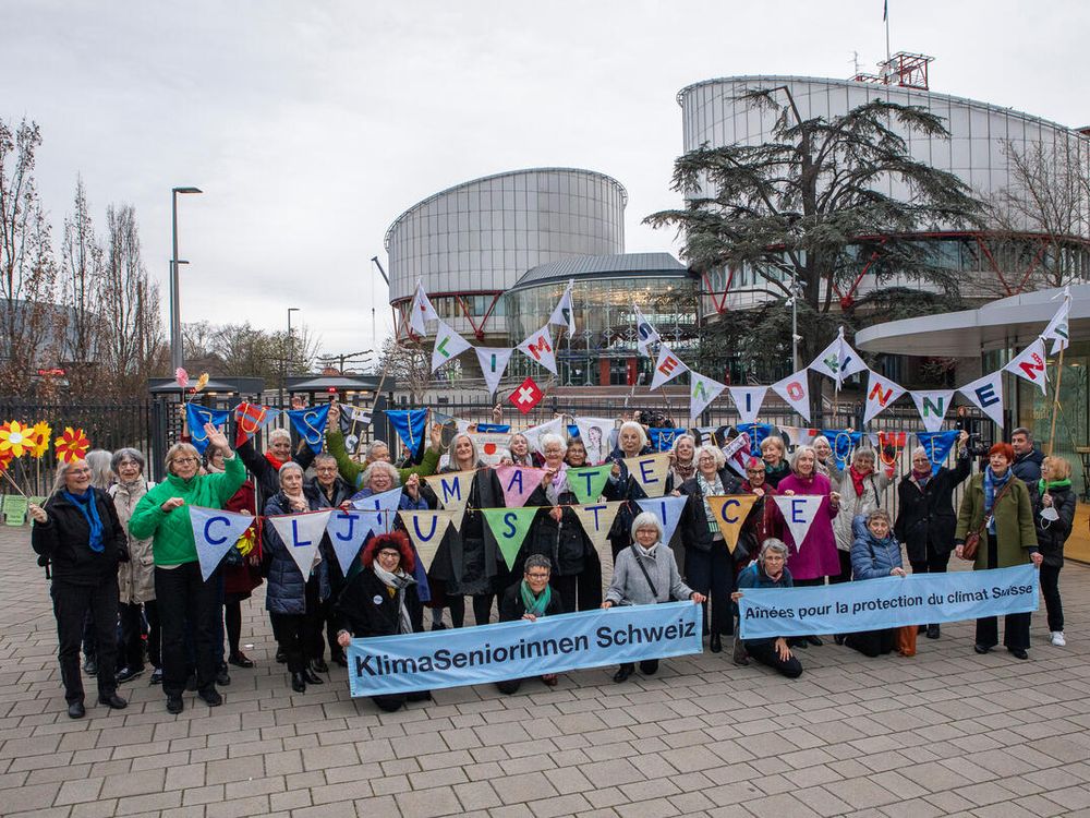 Group of seniors with climate change signs