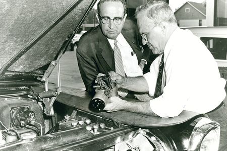 Ralph Teetor (right), cruise control in hand, with William Prossner, president of Perfect Circle, in 1957.