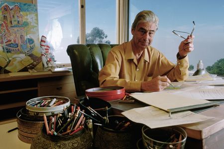 Dr. Seuss drawing at his desk