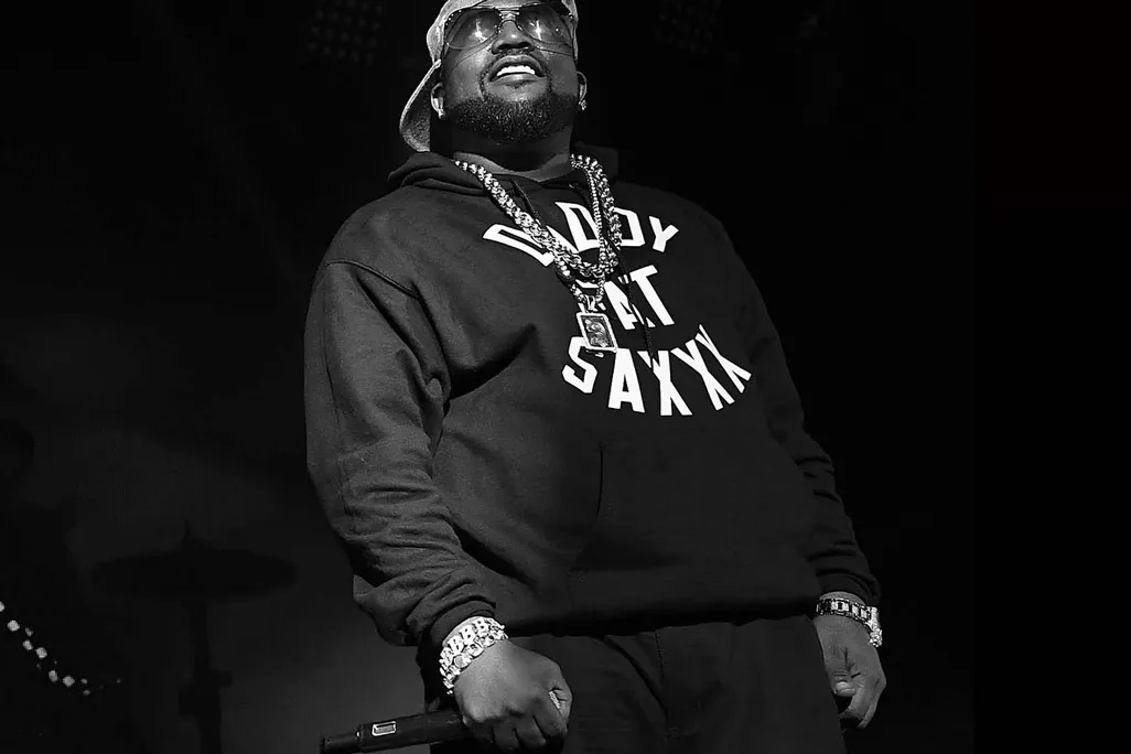 a black and white photograph of a hip-hop artist on stage