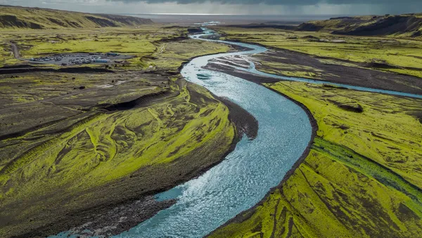 Glacial Serpent: Meltwater Carving Through Mossy Lava Fields thumbnail