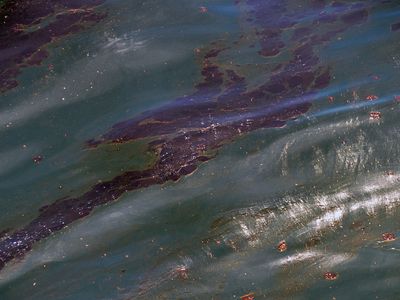 A large oil slick floats about a mile off Perdido Key, FL, where cleanup crews worked to recover the oil, Saturday, June 12, 2010.