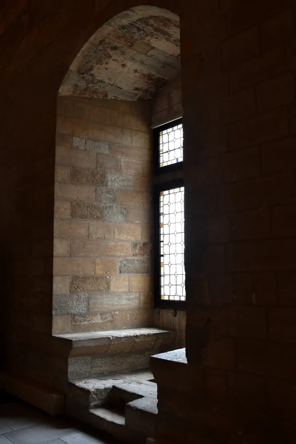 Empty stone seating area by window in palace thumbnail
