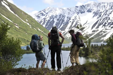 Backpackers hike near Crescent Lake in Alaska&#39;s Chugach National Forest.