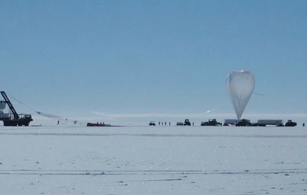 a balloon and other scientific equipment on the icy expanse of Antarctica
