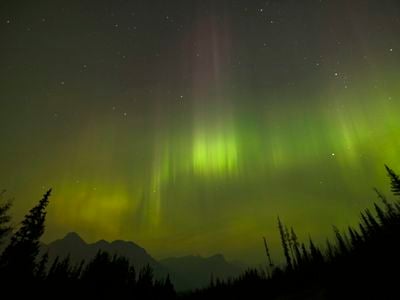 The northern lights as seen through a layer of wildfire smoke in Banff National Park in Alberta, Canada, in September 2022.