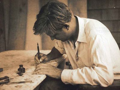 Robert Motherwell writing at his desk in Amagansett, New York, June 1944