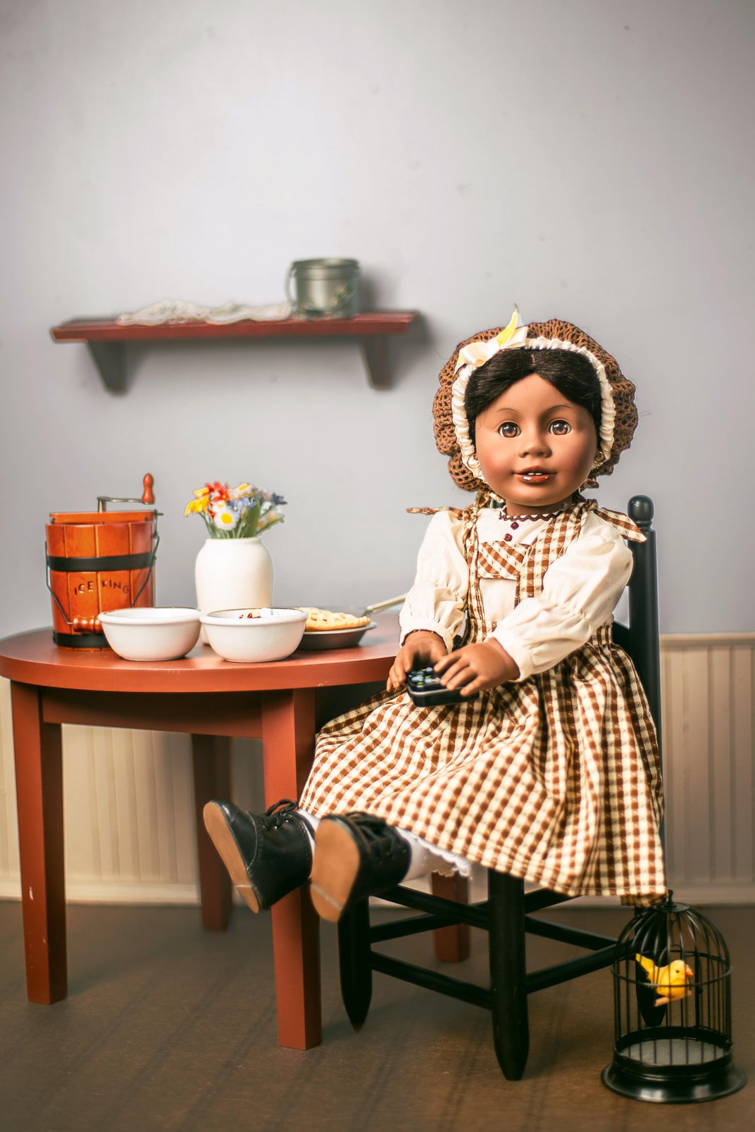Addy Walker doll sitting at a table