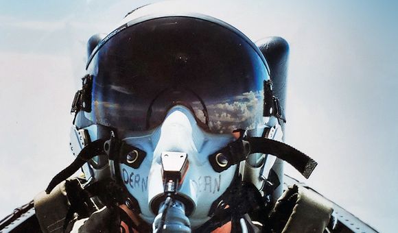 Selfie of Joy Dean in her flight helmet. Clouds are reflected in the visor.