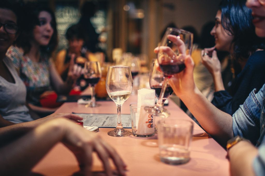 People around a table drinking wine