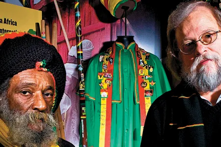Curator Jake Homiak (right) and adviser Ras Maurice Clarke make the sign of the trinity, a Rastafarian symbol of reverence.