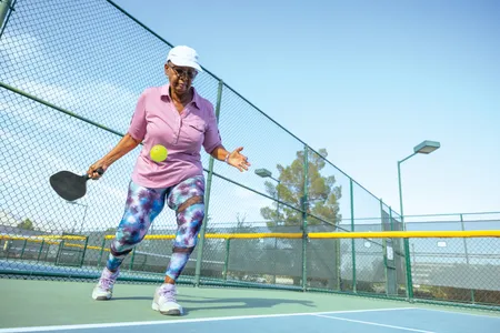 A player serving on an outdoor court. In 2022, the Association of Pickleball Professionals estimated there were 36.5 million pickleball players in the U.S.