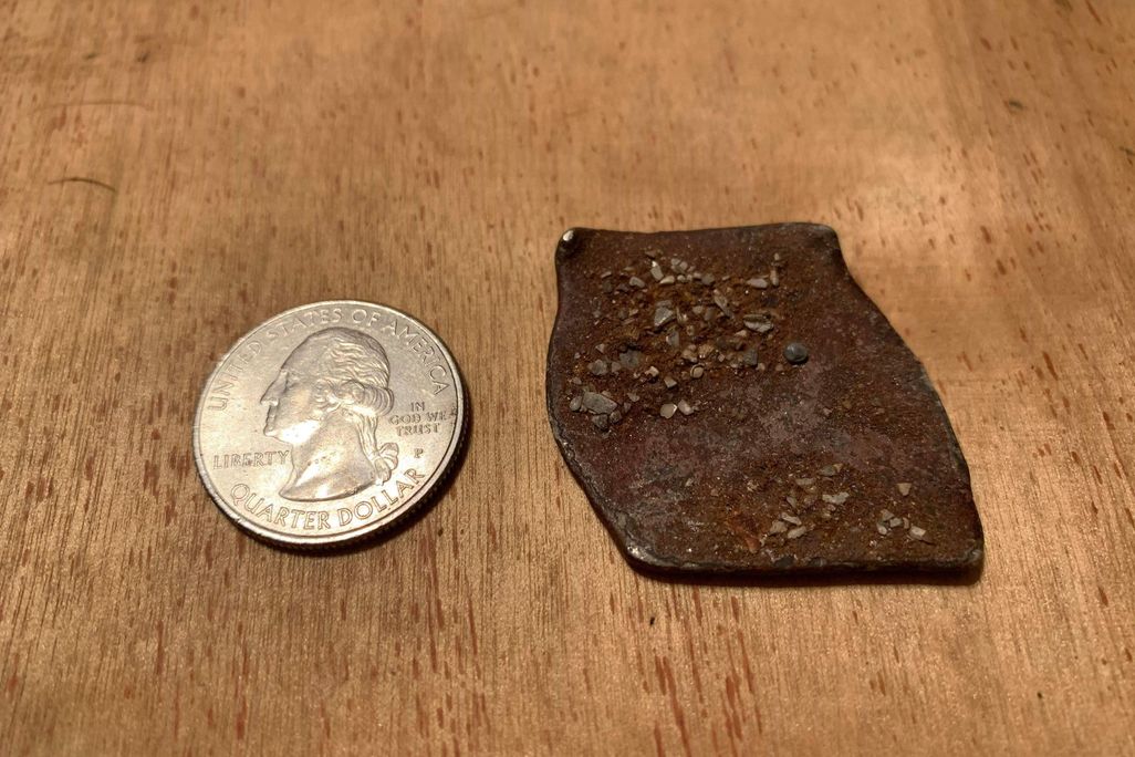 Shipwreck coin next to quarter