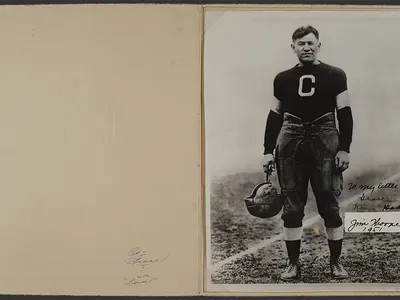 Jim Thorpe (Sac and Fox), with the inscription “To my little girl Grace From Dad Jim Thorpe 1951.” The photo, in the original folder frame, shows Thorpe during his career with the Canton Bulldogs football team, ca. 1915 to 1920. Grace Thorpe Collection, NMAI.AC.085 (pht_092_002). (National Museum of the American Indian Archives Center, Smithsonian)