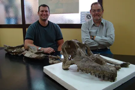 Paleontologists Matt Lamanna and Ruben Martinez with the skull of Sarmientosaurus