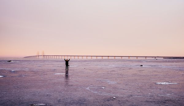 Lonely person standing on the frozen ocean on a cold morning thumbnail